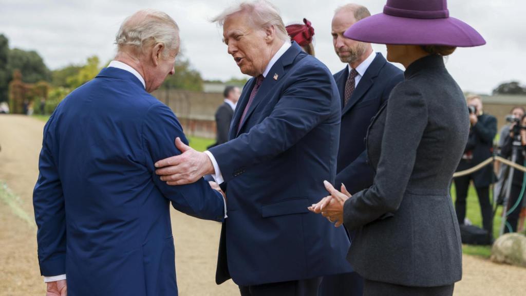 Donald Trump saludando a Carlos III.