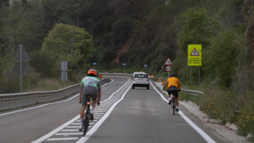 Imagen de archivo de dos personas circulando en bicicleta por una carretera.
