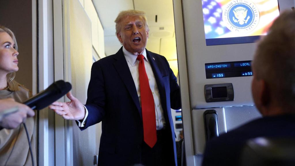 Donald Trump atendiendo a los periodistas en el Air Force One durante el regreso a Washington desde Londres.