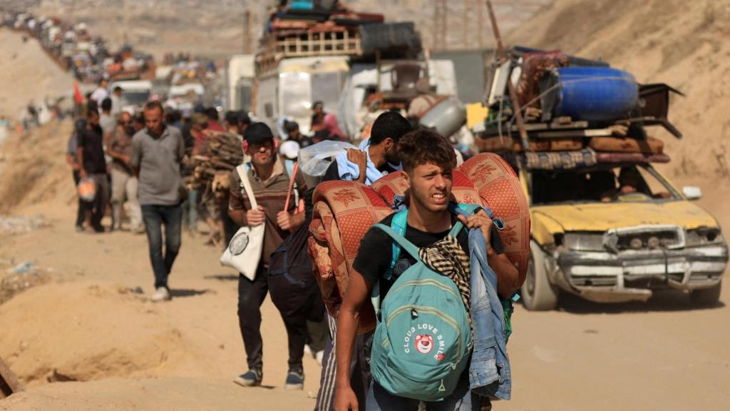 Desplazados palestinos se alejan de la Ciudad de Gaza ante el avance de las tropas israelíes.