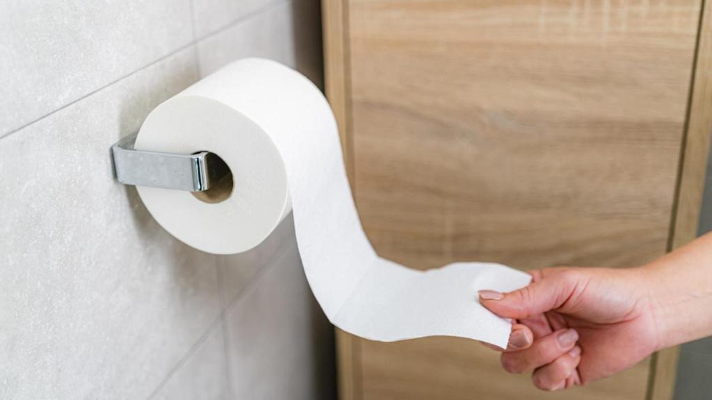 Una persona tirando de un rollo de papel.