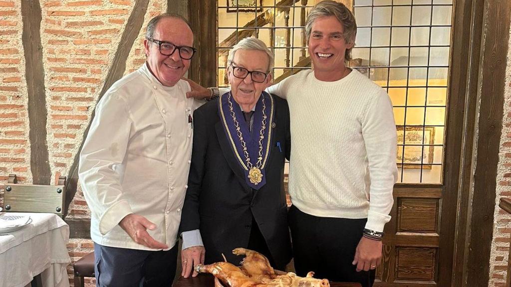 Carlos Baute con Alberto Cándido partiendo el cochinillo asado en el Mesón Cándido