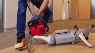 Robot de Unitree siendo atacado por una motosierra.