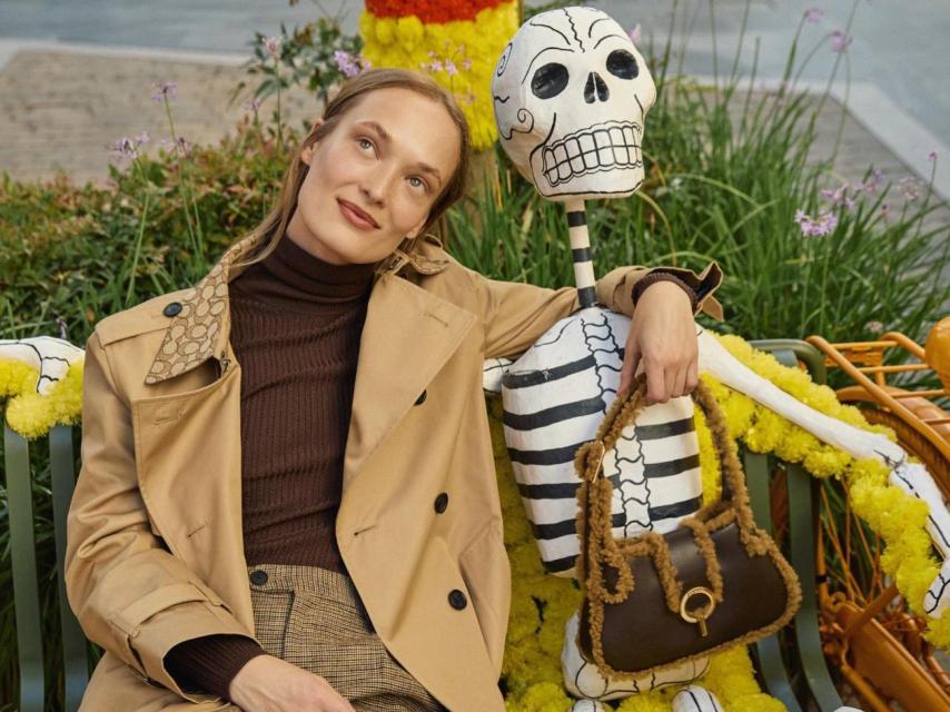 Una mujer posando junto a uno de los esqueletos típicos del Día de los Muertos.