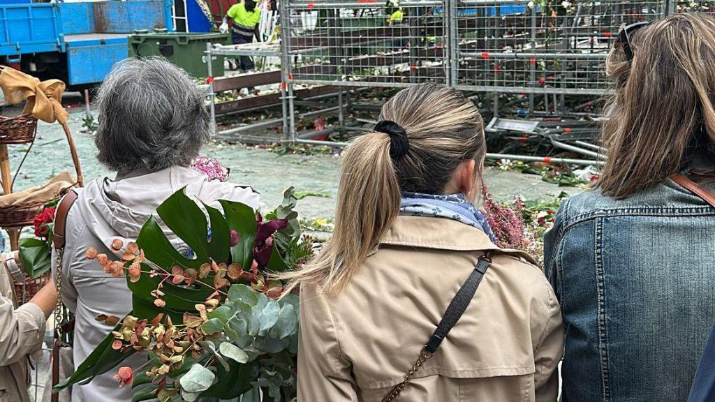 Los ciudadanos presentes llevándose las flores mejor conservadas.