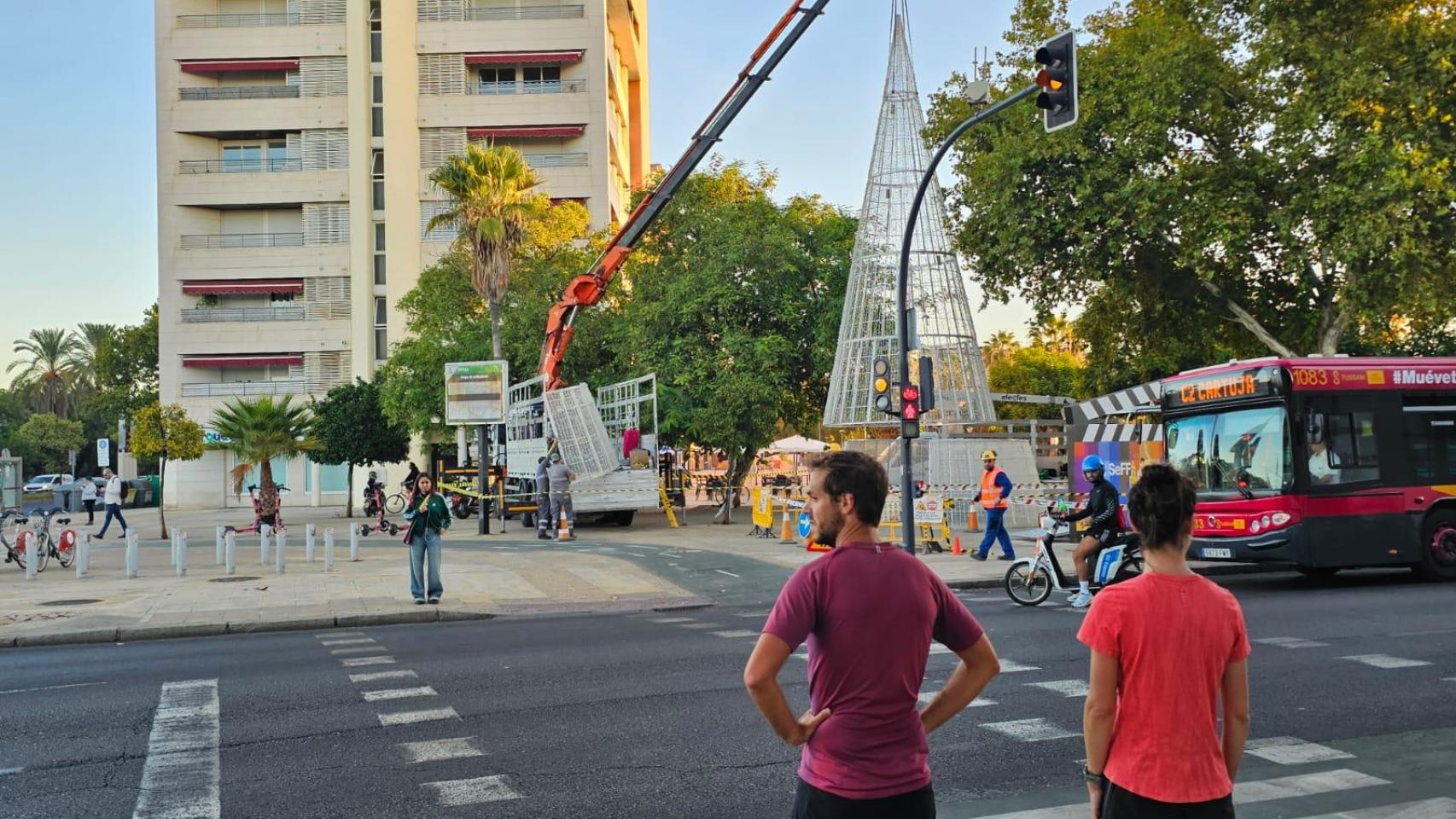 Imagen del montaje de las luces de Navidad y gente en manga corta.