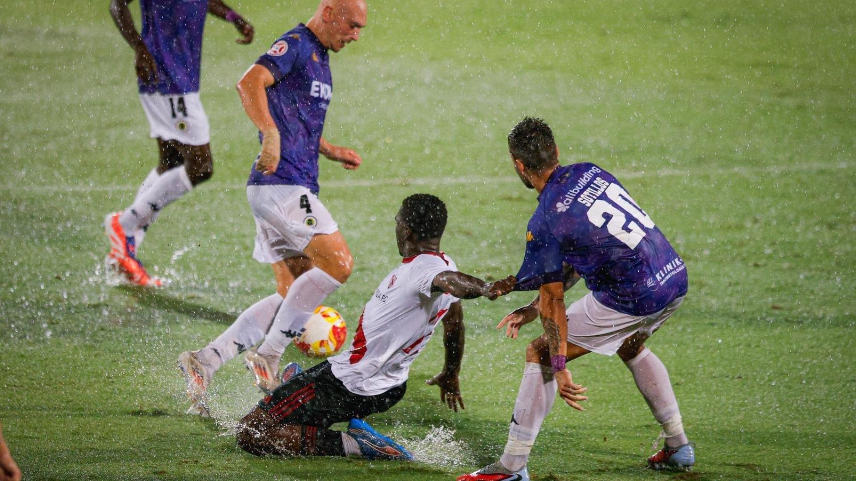 Rentero y Sotillos intentan frenar a un jugador del Sevilla Atlético.