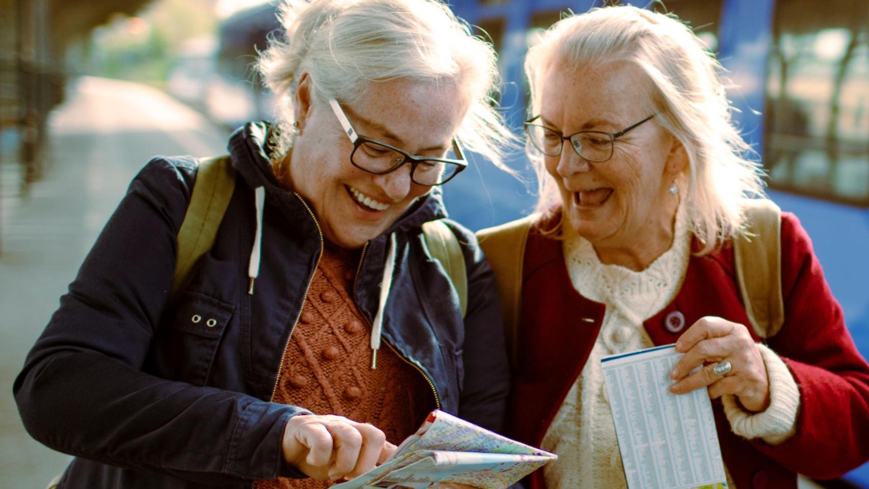 Dos amigas consultan un mapa turísitco