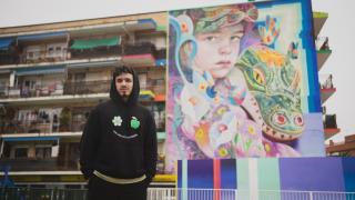 El artista Murfin junto a su mural Niños Perdidos, ubicado en Fuenlabrada.