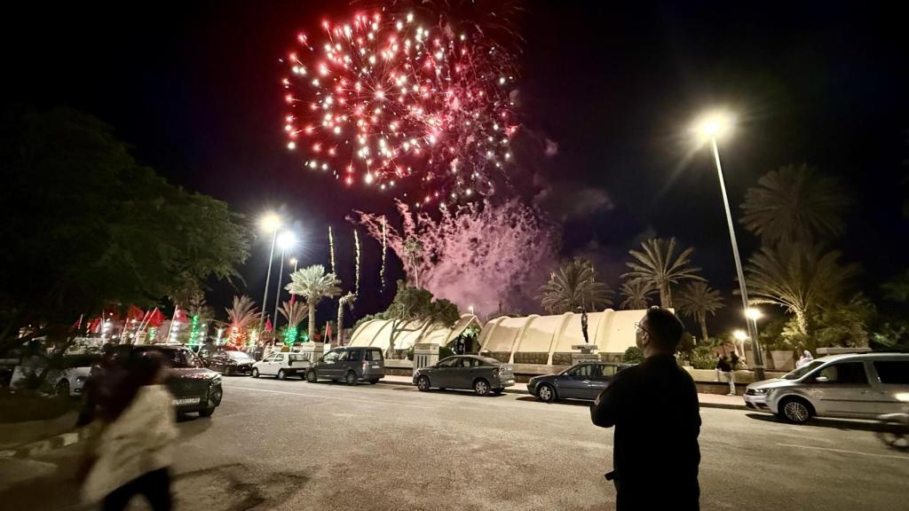 Un hombre mira con atención los fuegos artificiales que celebran el 50 años de la Marcha Verde en bulevar Hassan II de Dajla.
