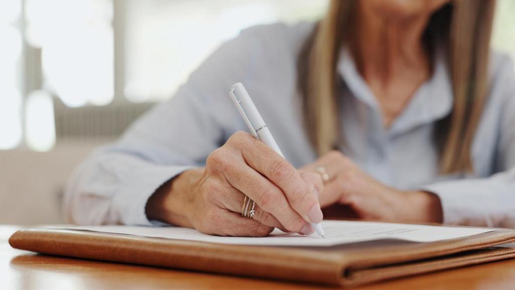 Una mujer firmando papeles.