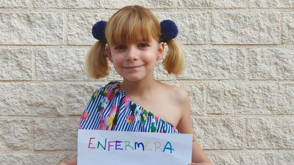 Emma, en su graduación de Infantil, mostrando la profesión a la que se quiere dedicar cuando sea adulta.