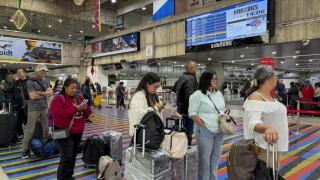 Fotografía de un grupo de viajeros este lunes en el aeropuerto internacional Simón Bolívar, que sirve a Caracas, en Maiquetía (Venezuela).