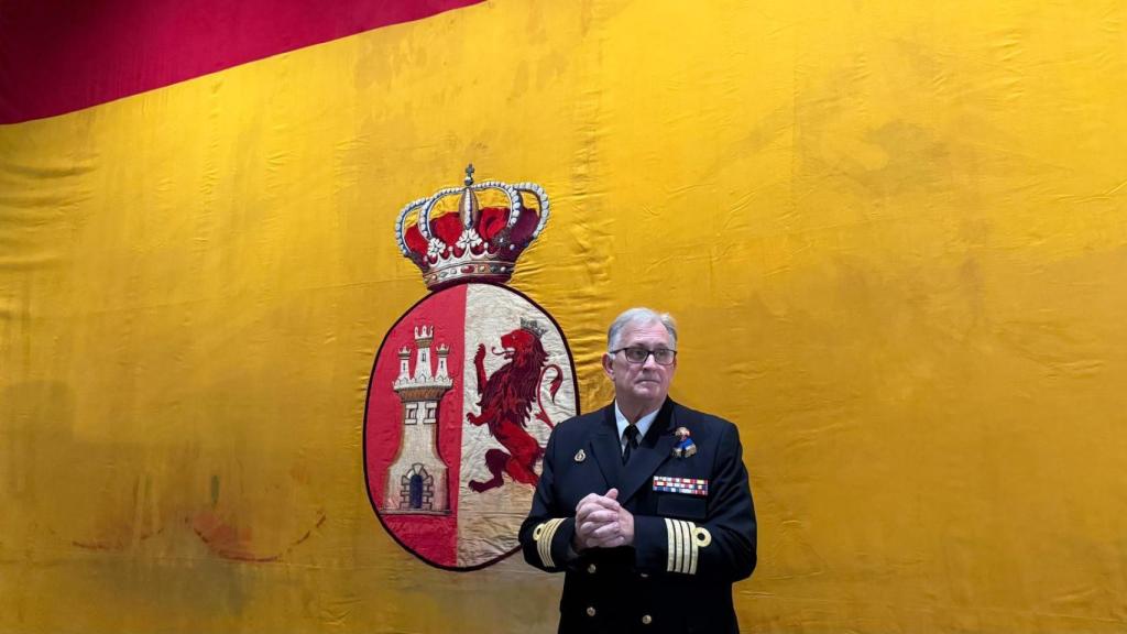 El director del Museo Naval, capitán de navío Juan Escrigas Rodríguez ante la bandera del Crucero María Mercedes.