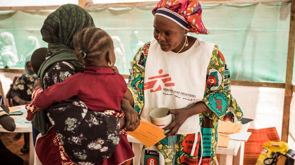 Una trabajadora de MSF atiende a una mujer y a su bebé que han huido de Sudán.