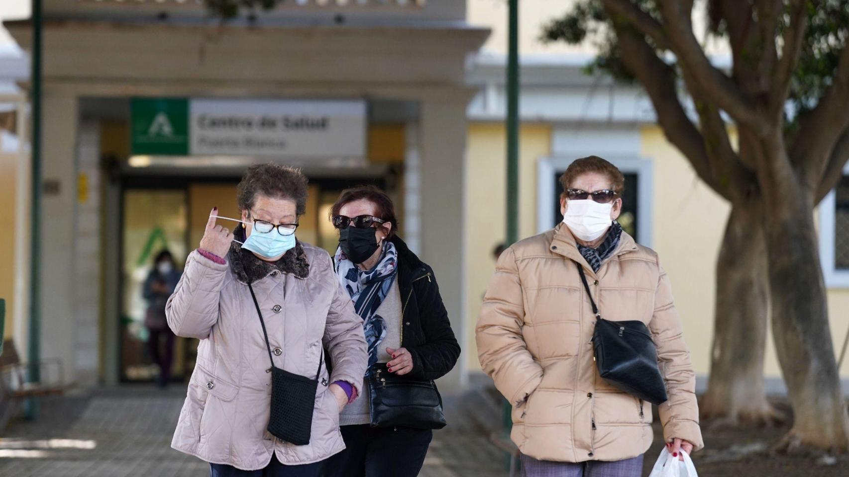 Varias mujeres mayores saliendo de un centro de salud.