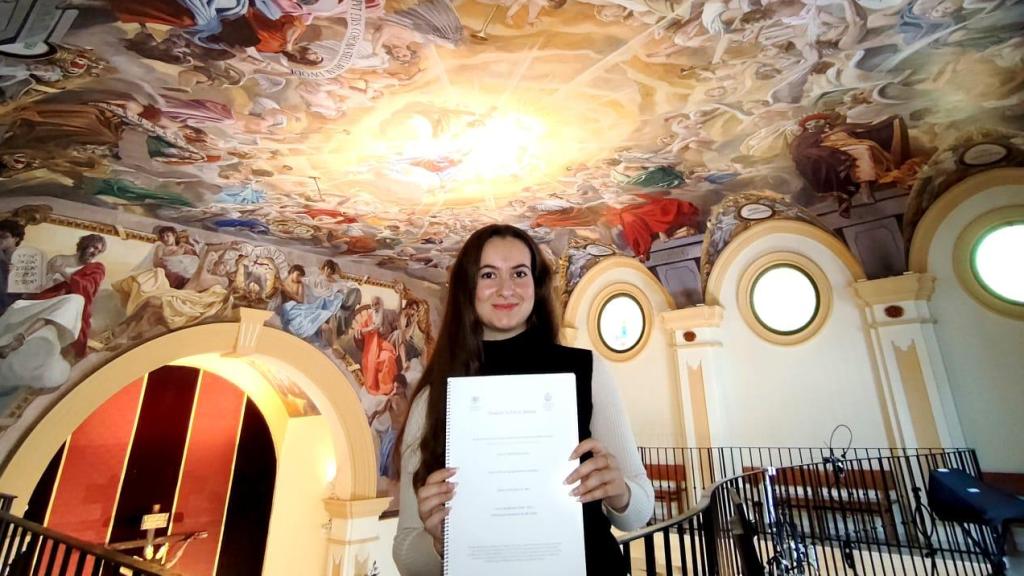 Marta Bleda, artista malagueña, junto a la obra de Raúl Berzosa.