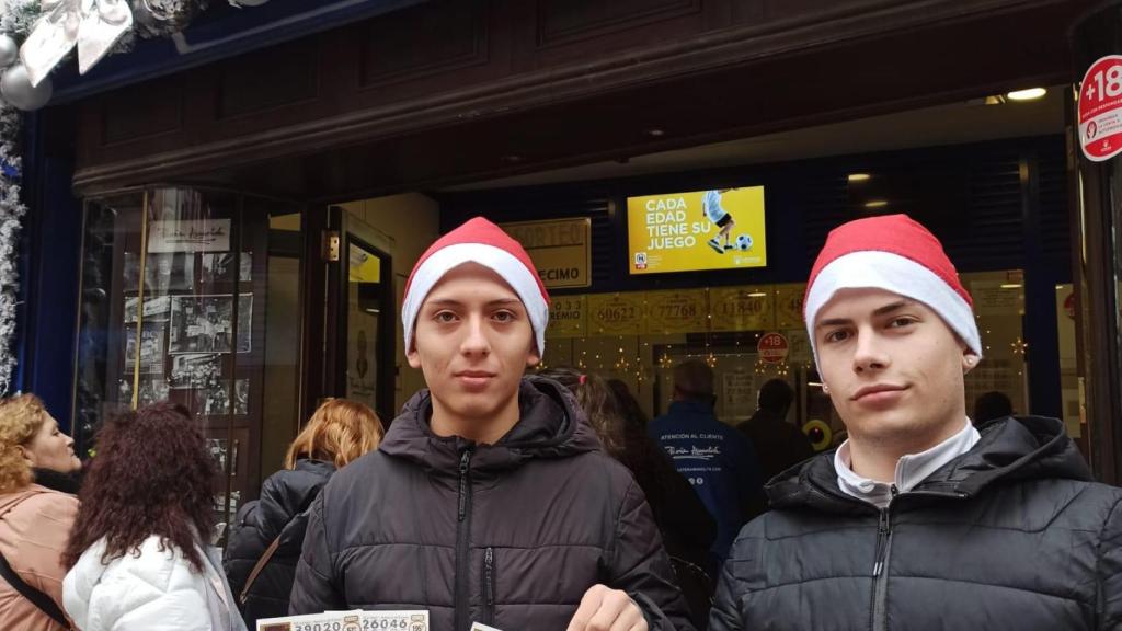 Darío y Richard posando con sus décimos frente a Doña Manolita