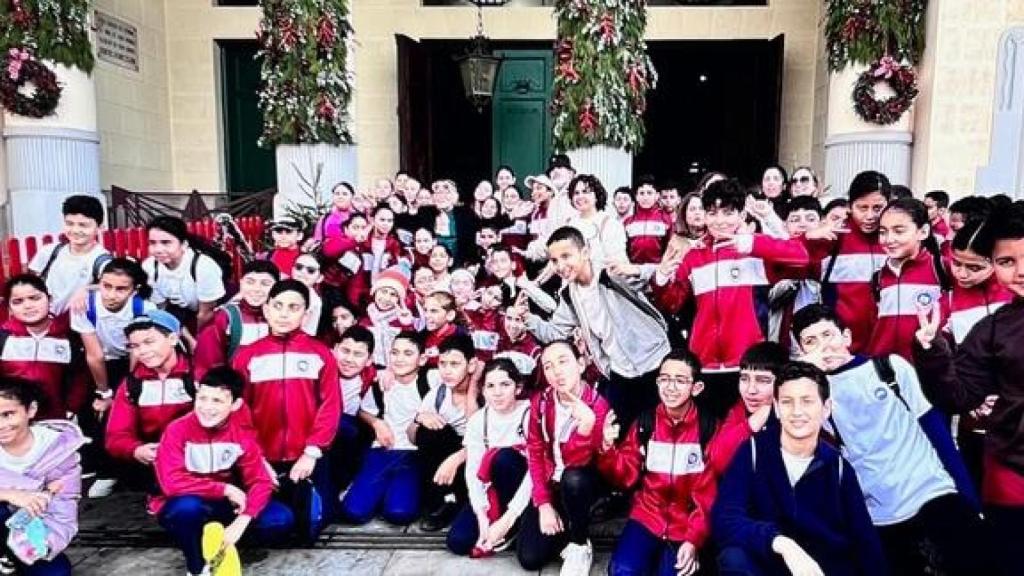 Arrabal junto a un grupo de niños.