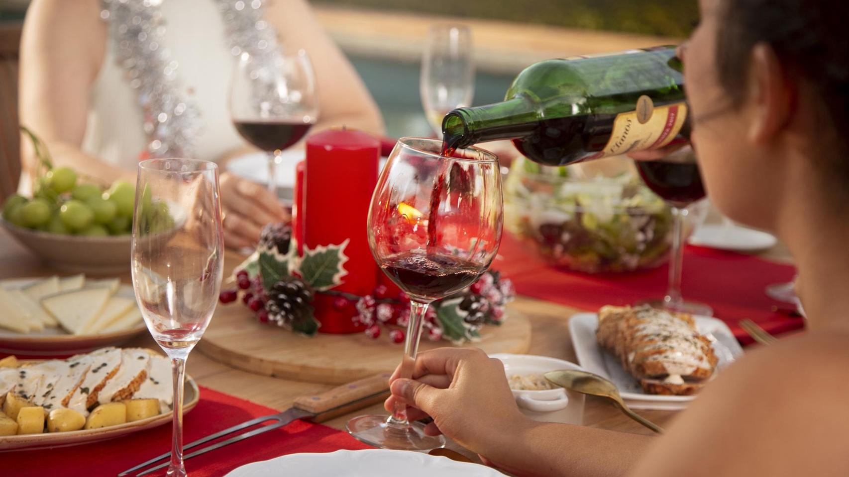 Familia disfrutando de la Navidad alrededor de la mesa