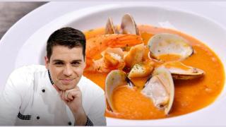 Sergio Fernández junto a un plato de crema de marisco.