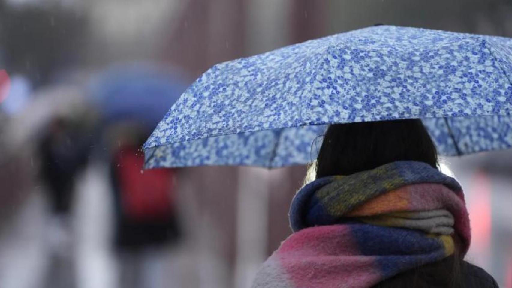 Imagen de una mujer con paraguas.