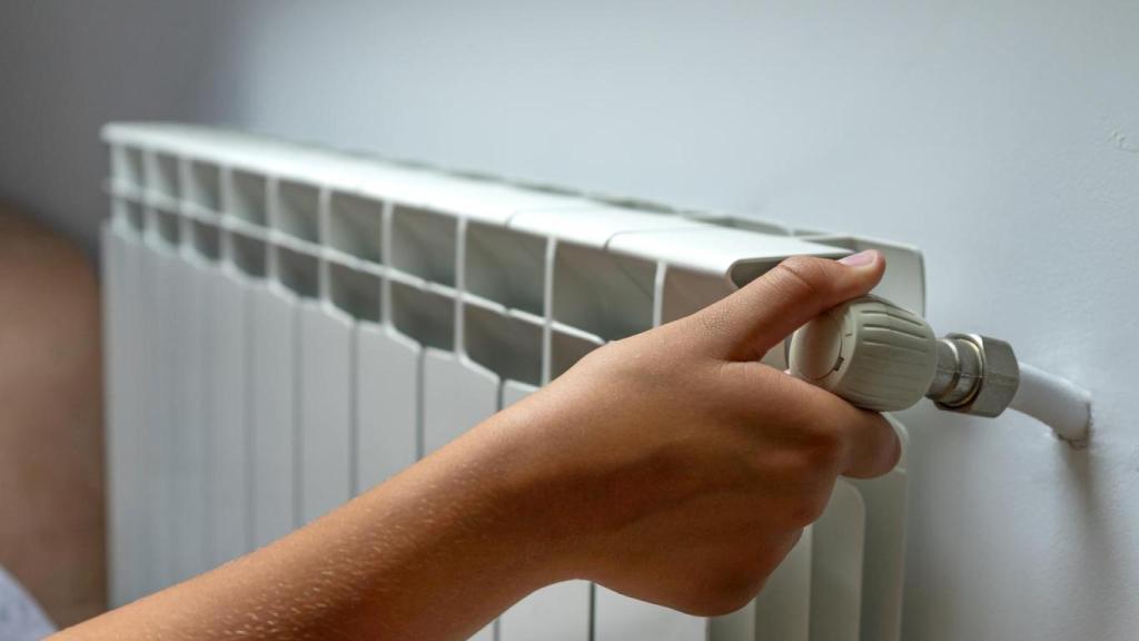 Mujer ajustando el radiador.