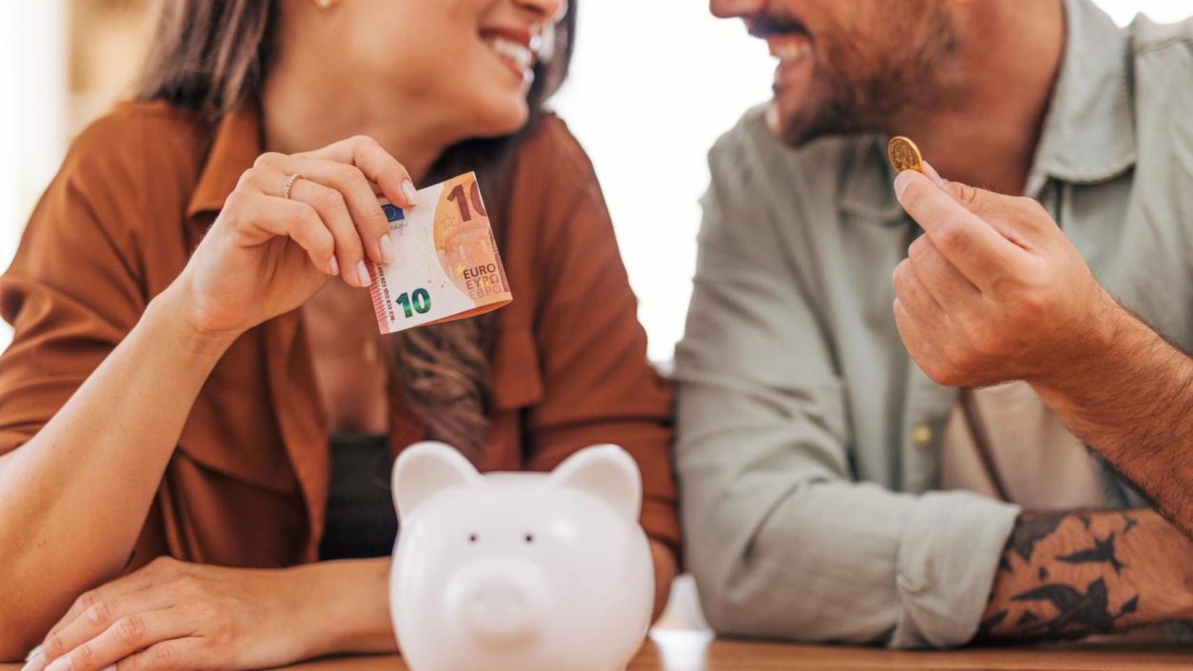 Una pareja joven ahorrando dinero.