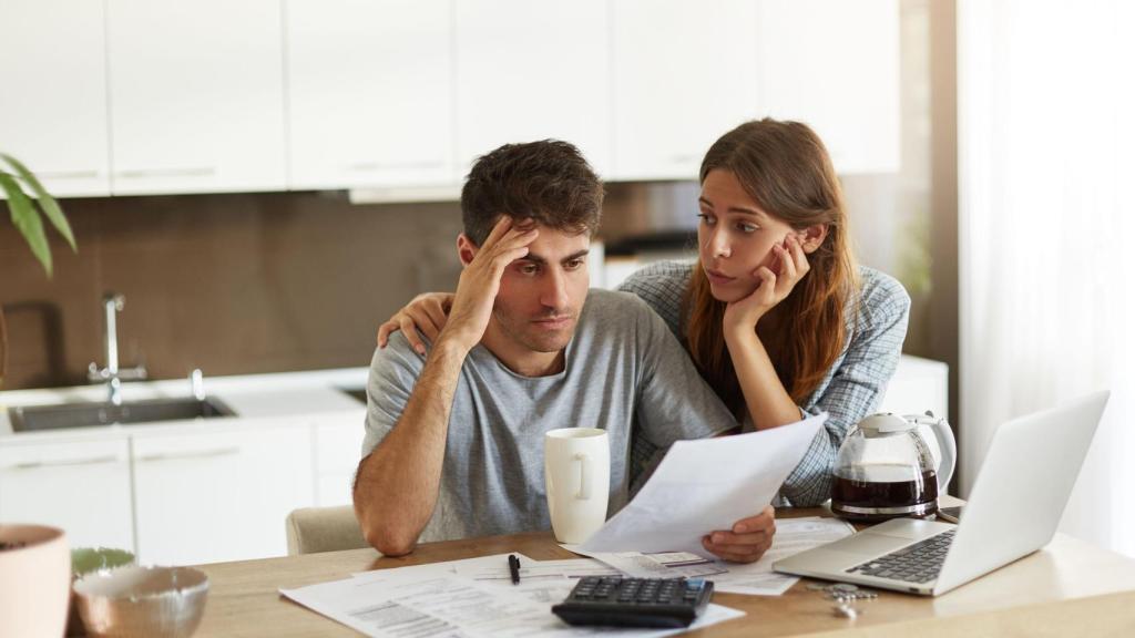 Representación de una pareja joven revisando sus las deudas