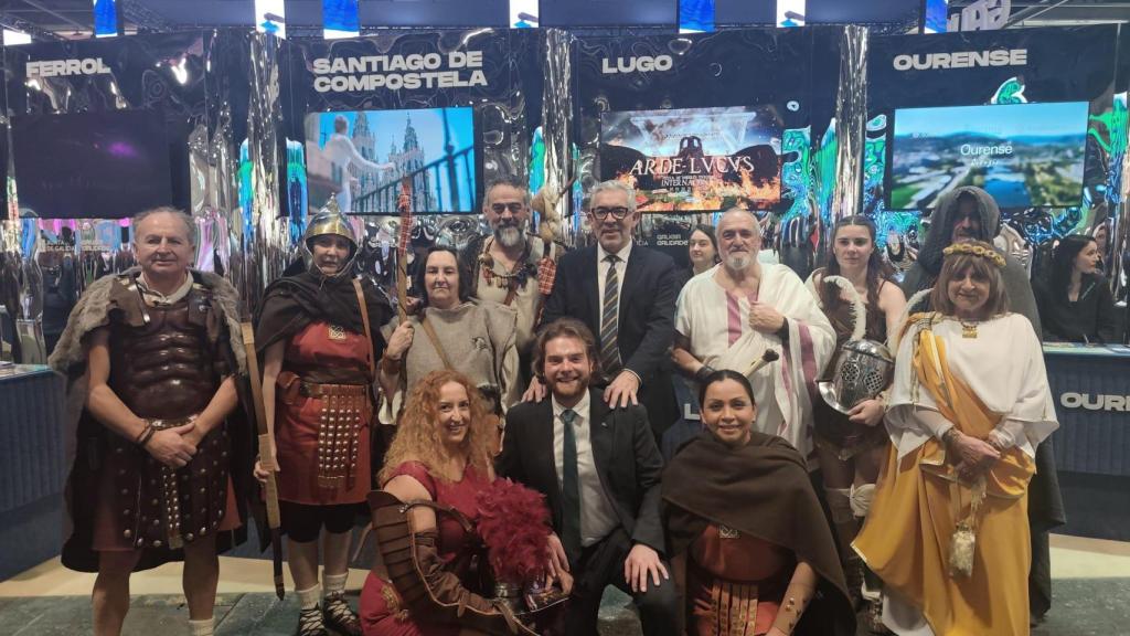 Miembros de asociaciones participantes en el Arde Lvcvs rodean al alcalde de Lugo, Miguel Fernández, de pie en el centro.