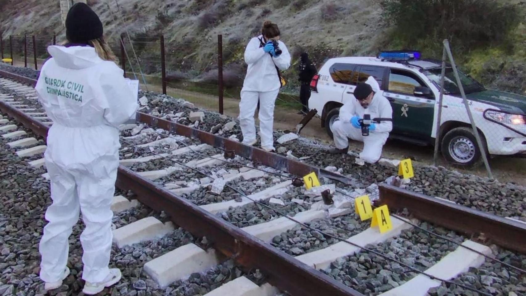 Los investigadores de la Guardia Civil fotografían el raíl roto que procovó el accidente de Adamuz (Córdoba).