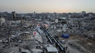 Dozens of Palestinians gather to break their fast next to the rubble of residential buildings destroyed during the Israeli offensive on Gaza.