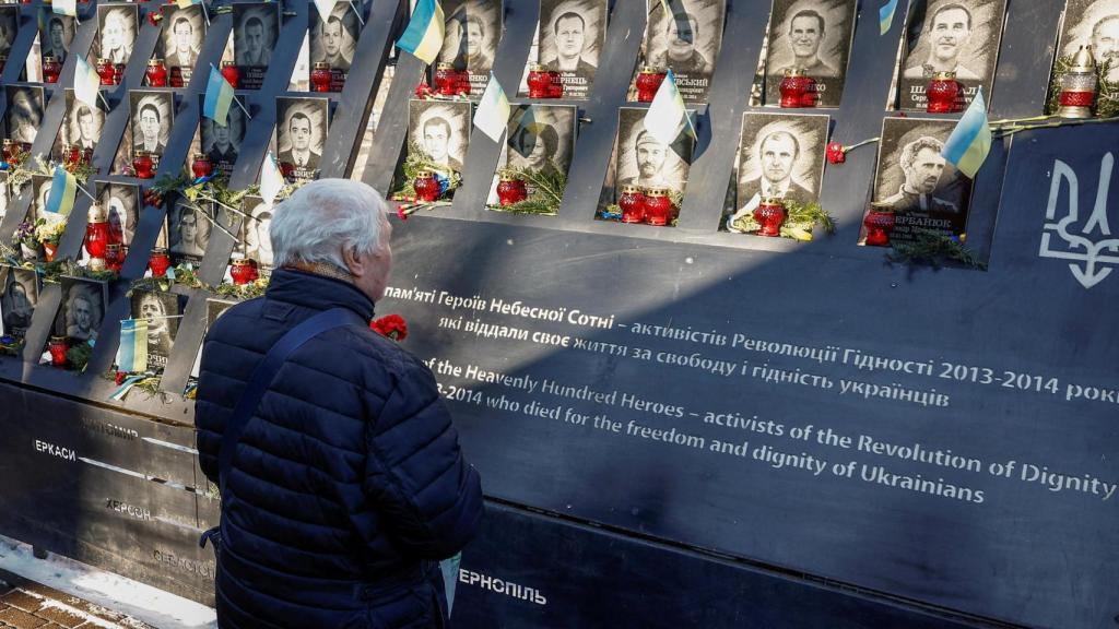 A person commemorates a memorial for victims fallen in war conflicts in kyiv.
