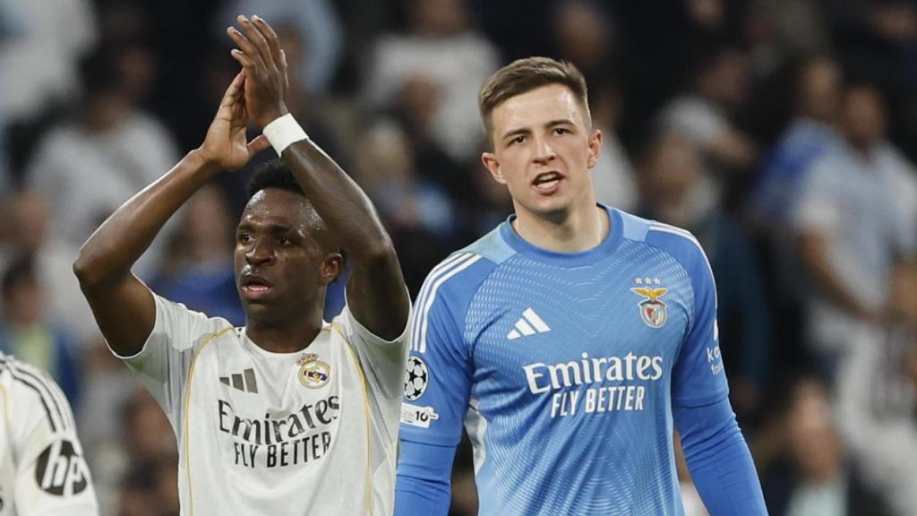 Vinicius, with Trubin in the background, greets the fans after the game