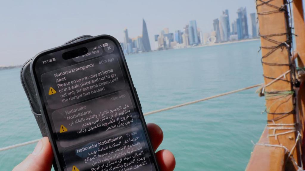 A resident in Qatar receives a mobile alert to warn of missiles launched in retaliation by Iran.