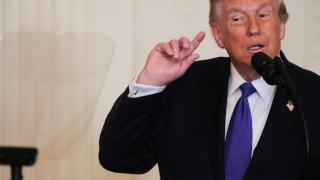 Donald Trump gestures while listening to construction noise during a Medal of Honor ceremony at the White House.