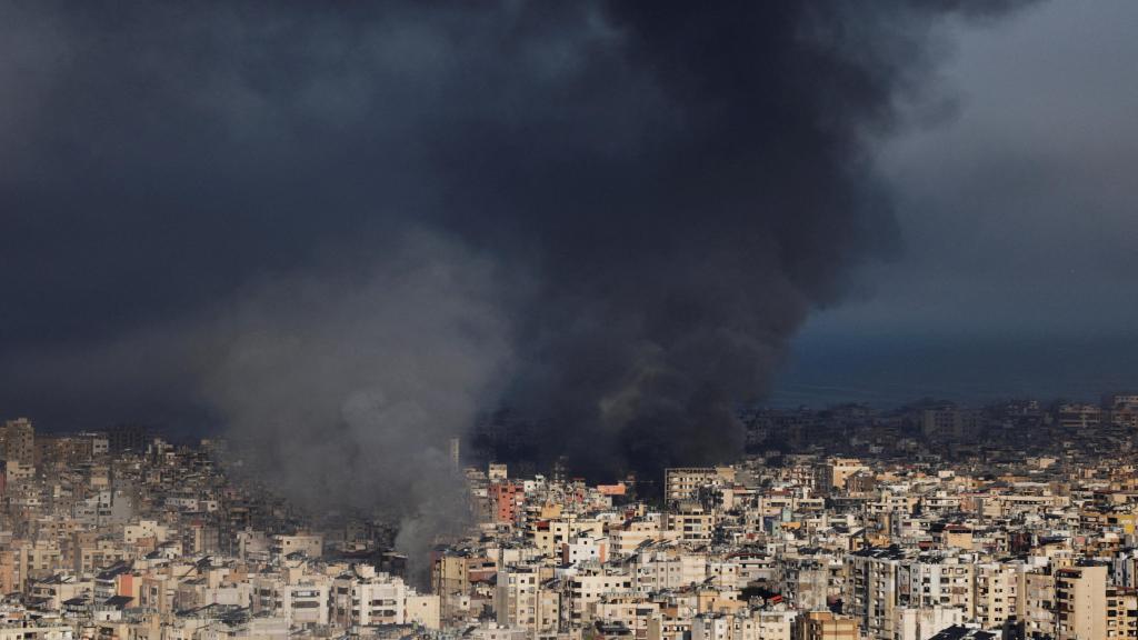 A large column of black smoke fills the sky over Beirut after the Israeli attacks.