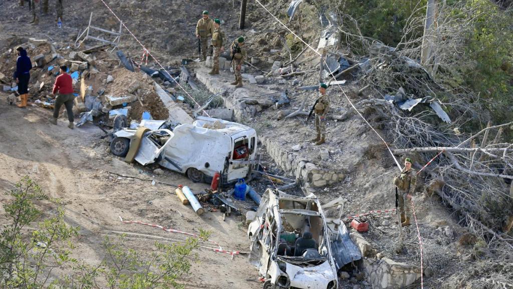 Lebanese soldiers and rescue teams inspect the impact of an Israeli attack in Kfardounine.