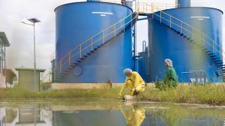Personal de control de calidad del agua y científicos que usan EPP que trabajan en el agua de muestra y analizan la calidad, la industria y el medio ambiente.
