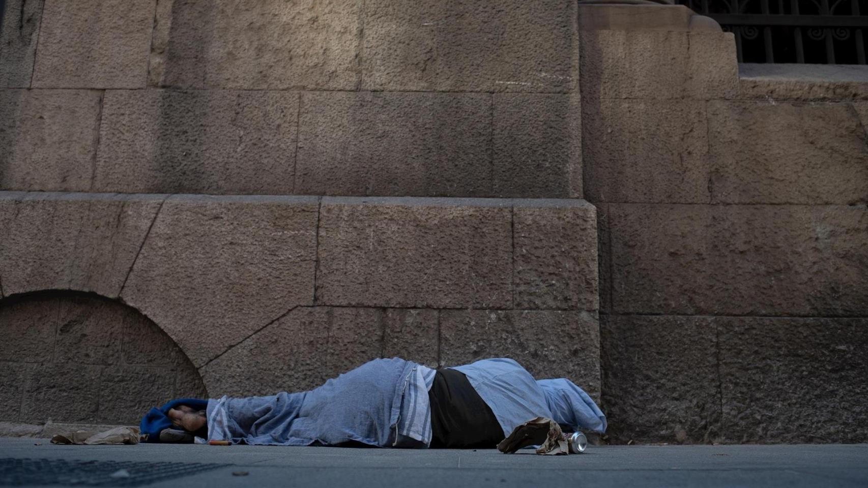Una mujer duerme en la calle, imagen que refleja la vulnerabilidad social