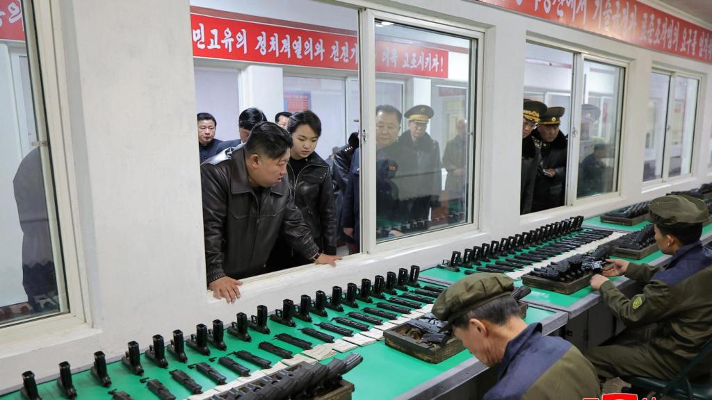 Kim Jon-un and his daughter Kum Ju-ae review the production of the new North Korean pistol.