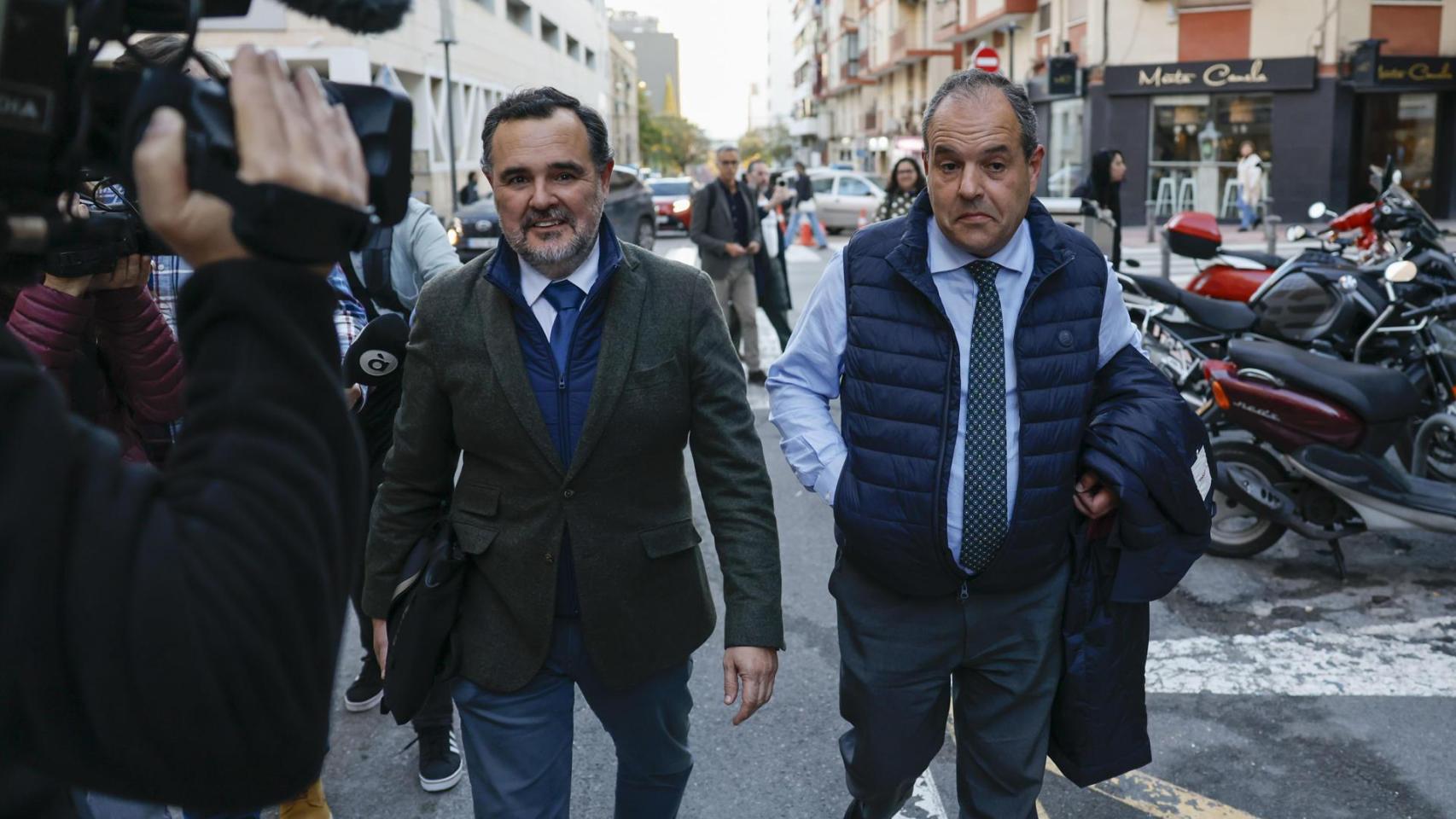 El presidente de la Cámara de Comercio de Alicante, Carlos Baño (d), saliendo de la Comisaría Provincial de Alicante.