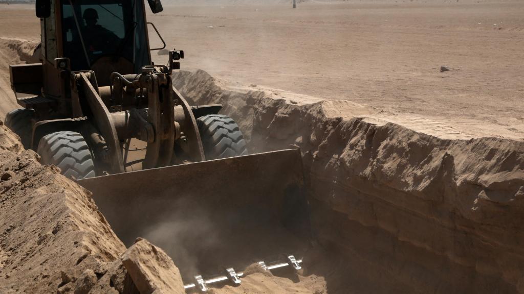 An excavator inside some ditches on Chile's northern border with Bolivia and Peru.