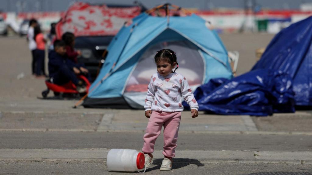 A girl plays in a camp for displaced people fleeing Israeli bombs.