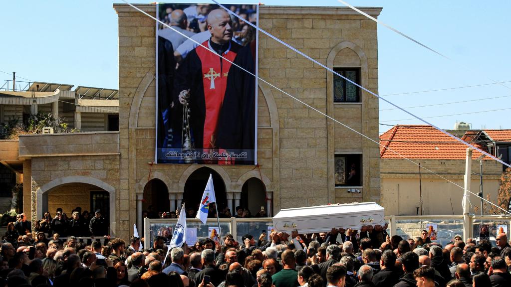 A photograph of Father Pierre El Rahi presides over his funeral in the village of Klaya.