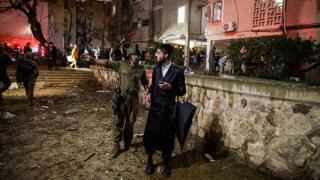 An Israeli soldier secures the impact zone after the Iranian missile bombardment hit residential buildings in Arad, southern Israel.