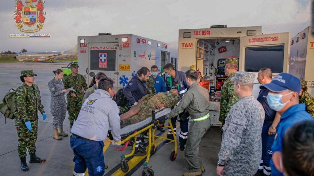 Fotografía cedida por las Fuerzas Militares de Colombia (FFMM) que muestra a integrantes de organismos de rescate trasladando a un herido de un accidente aéreo este lunes, en el Comando Aéreo de Transporte Militar (CATAM) en Bogotá (Colombia).