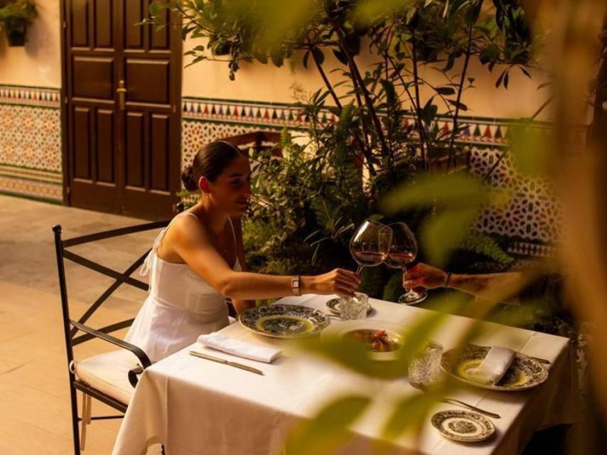 Una pareja brinda en el restaurante El Patio de El Pali, uno de los más exquisitos de la capital hispalense.