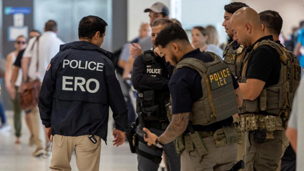 ICE agents, the US anti-immigration police, carrying out a raid at an airport.