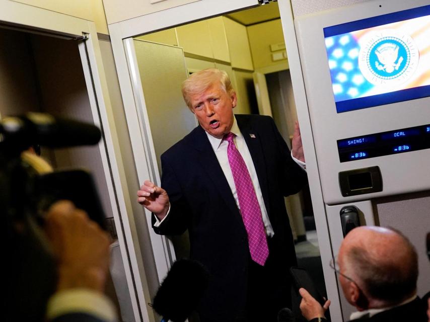Donald Trump aboard Air Force One with reporters in attendance.